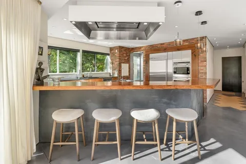 a dining room with furniture and a large window