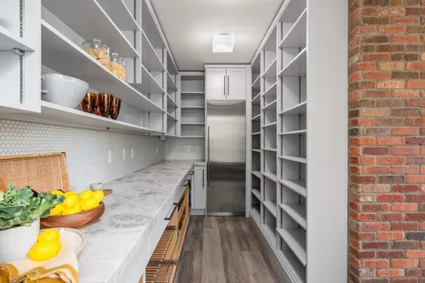 a view of walk in closet with clothes and shoes