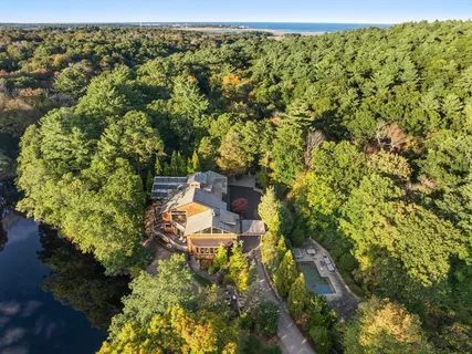 an aerial view of a house with a yard