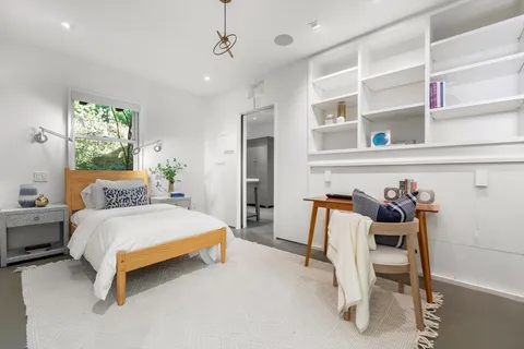 a bedroom with a bed and a desk