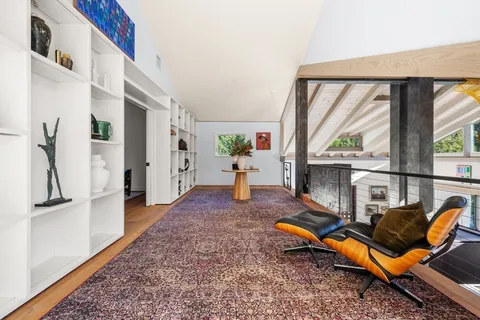 a living room with furniture rug and a large window