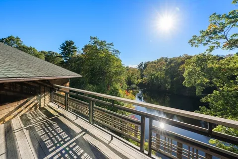 a view of balcony with wooden floor and fence