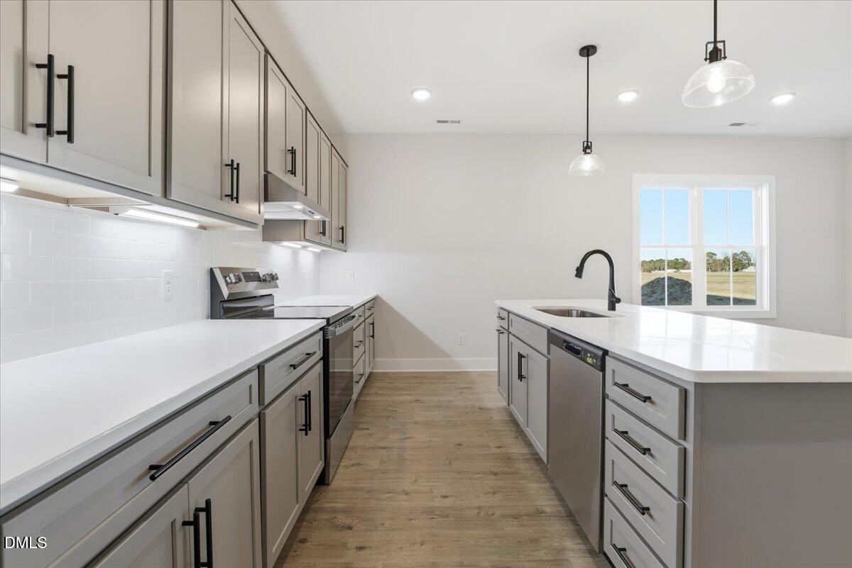 47 Gold Court Kenly, NC 27542 - Photo 11 of 32 a kitchen with stainless steel appliances a sink stove and cabinets