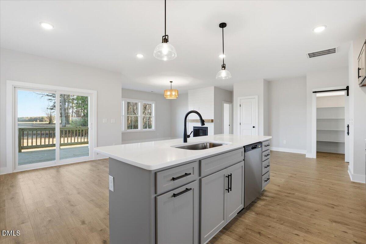47 Gold Court Kenly, NC 27542 - Photo 13 of 32 a large kitchen with sink and dishwasher with wooden floor