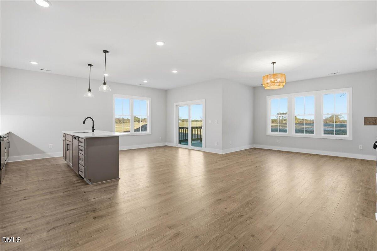 47 Gold Court Kenly, NC 27542 - Photo 16 of 32 a view of an empty room with window and wooden floor