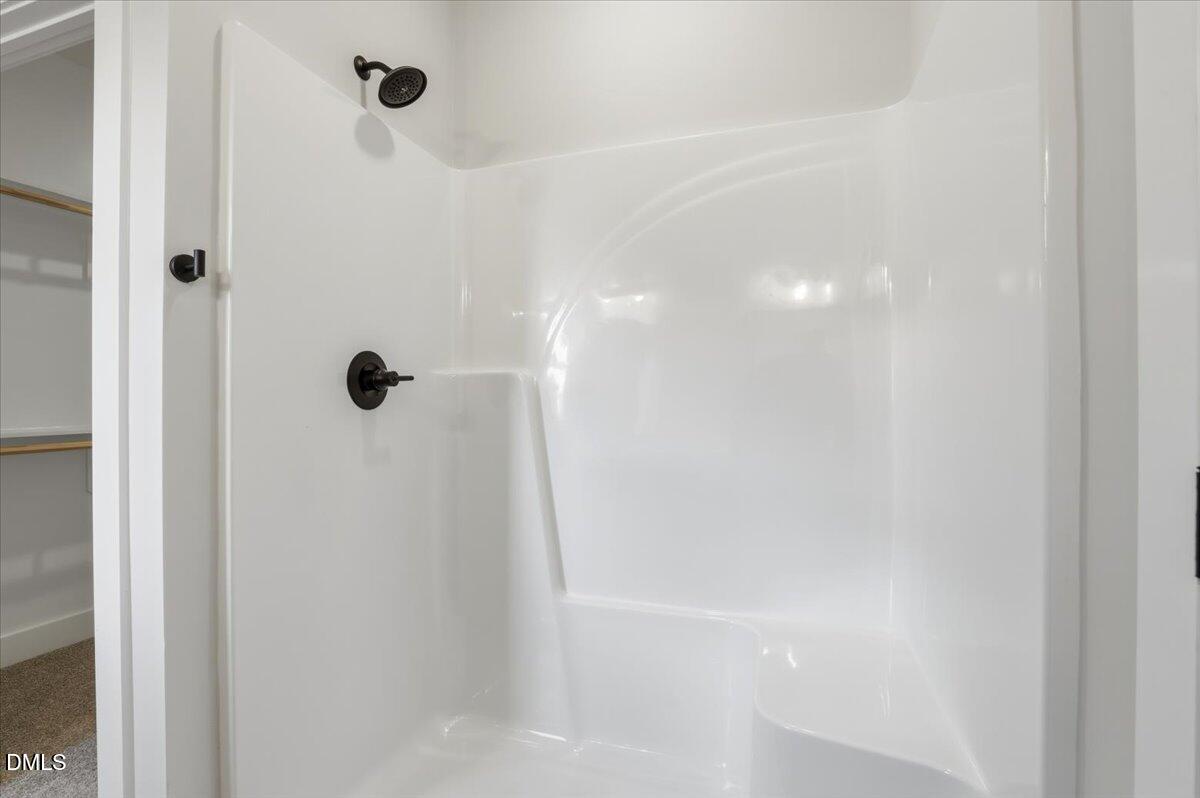 47 Gold Court Kenly, NC 27542 - Photo 20 of 32 a bathroom with a shower and a glass door