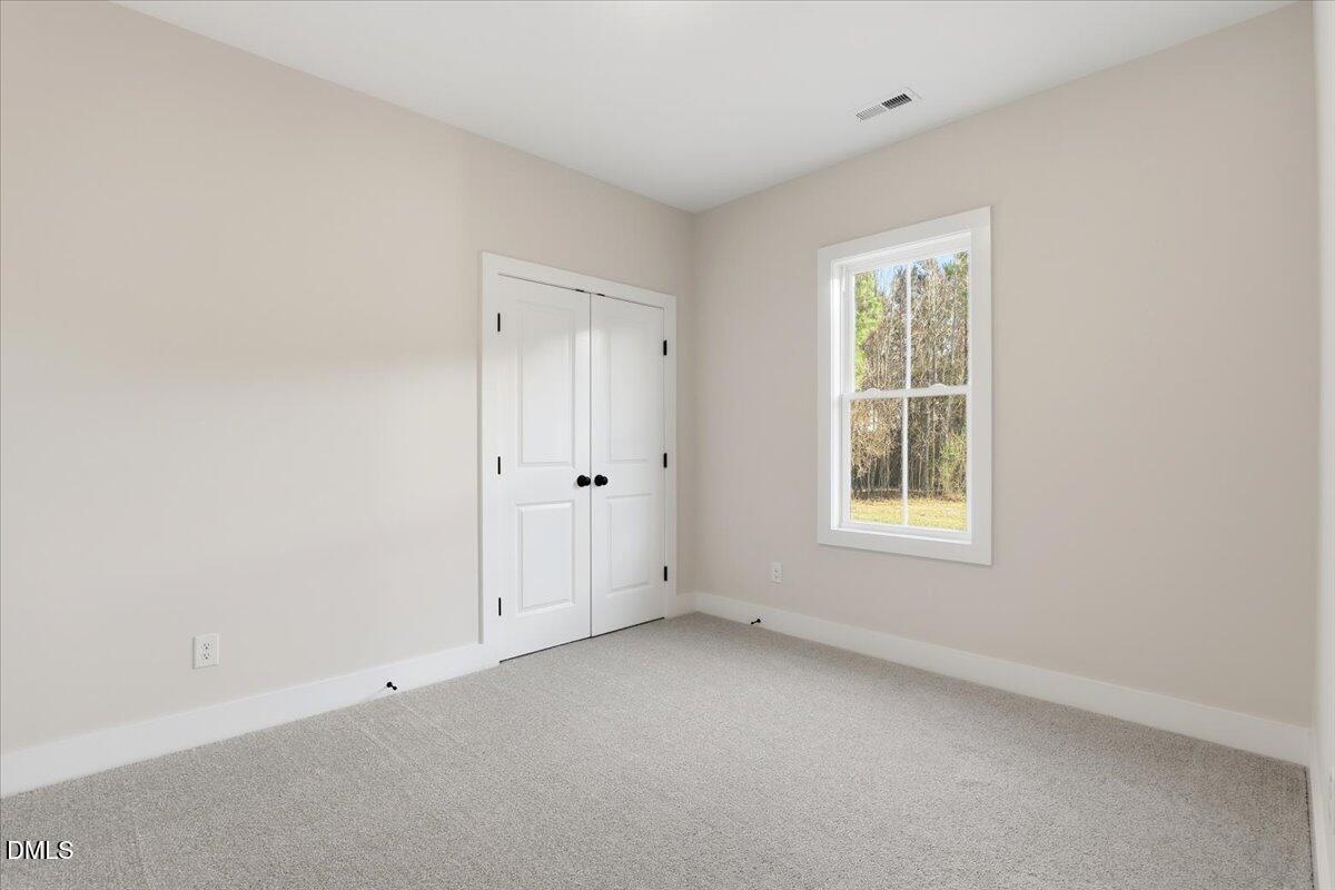 47 Gold Court Kenly, NC 27542 - Photo 26 of 32 an empty room with windows