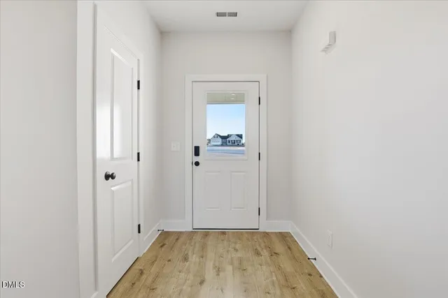 a view of a hallway with wooden floor