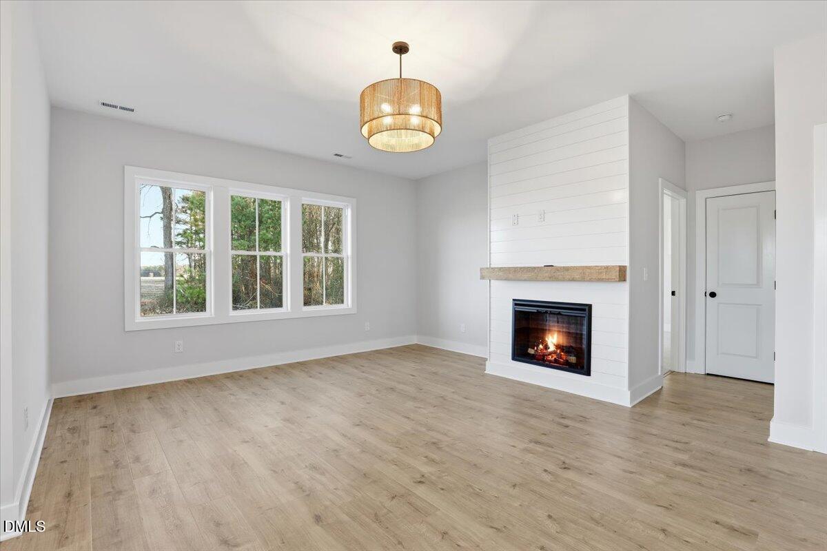 47 Gold Court Kenly, NC 27542 - Photo 5 of 32 a view of an empty room with a fireplace and a window