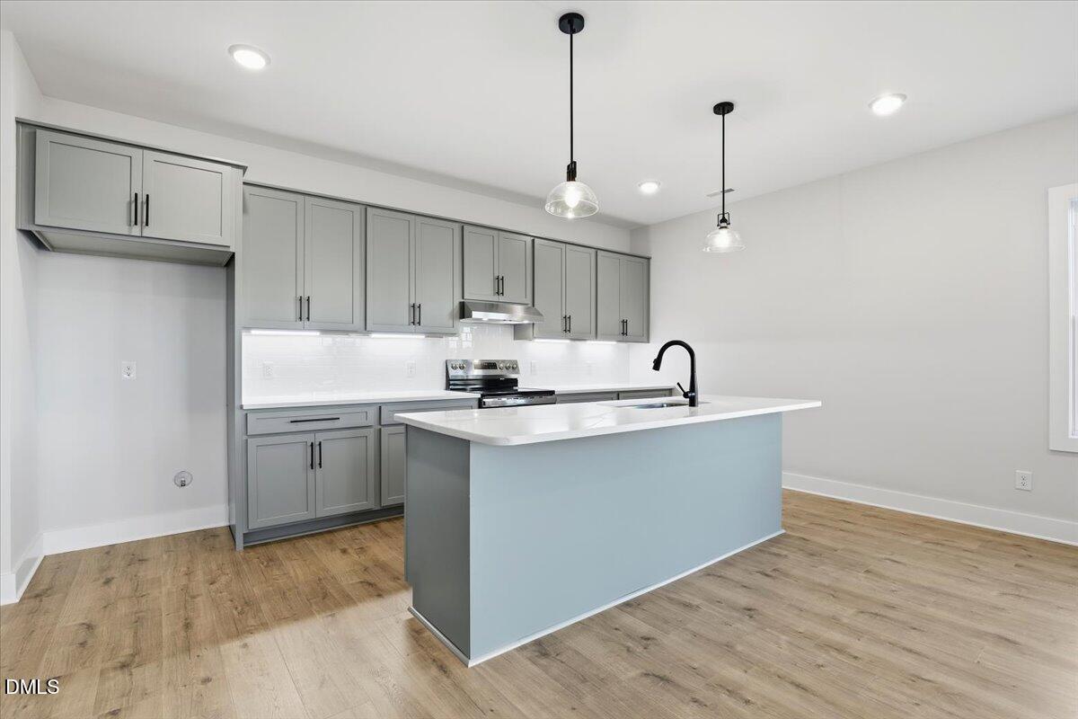47 Gold Court Kenly, NC 27542 - Photo 10 of 32 a kitchen with kitchen island a sink stainless steel appliances and cabinets