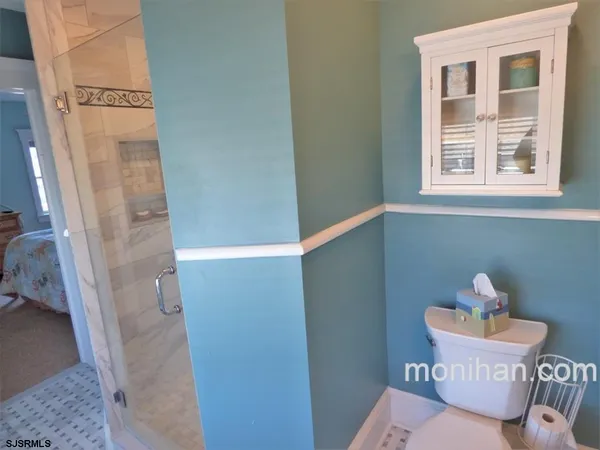 a bathroom with a sink and mirror with toilet