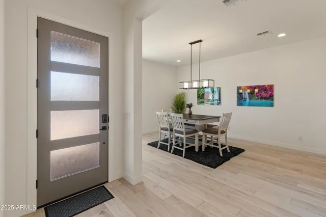 a view of a dining room with furniture wooden floor and chandelier