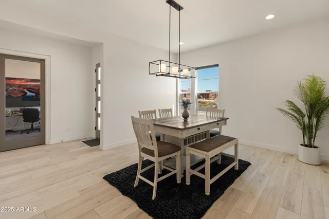 a picture of a glass door with a plant in the background