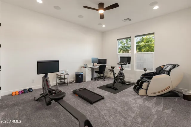 a living room with furniture kitchen view and a chandelier