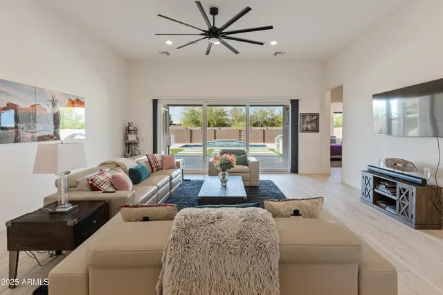 a spacious bedroom with a bed and a chandelier
