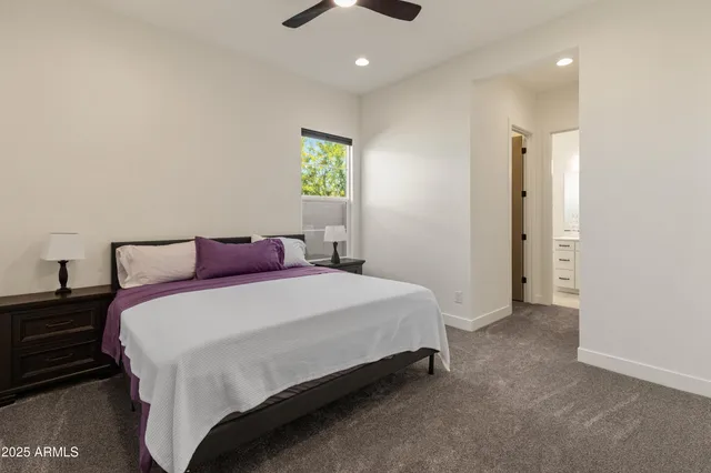 a dining room with stainless steel appliances kitchen island granite countertop a table chairs and a refrigerator