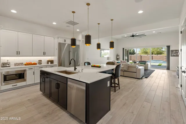 a kitchen with stainless steel appliances kitchen island a stove and a refrigerator
