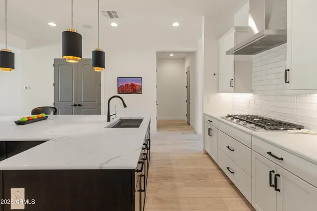 a spacious bathroom with a granite countertop sink mirror and a
