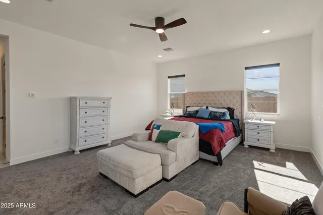 a spacious bathroom with a double vanity sink mirror and shower