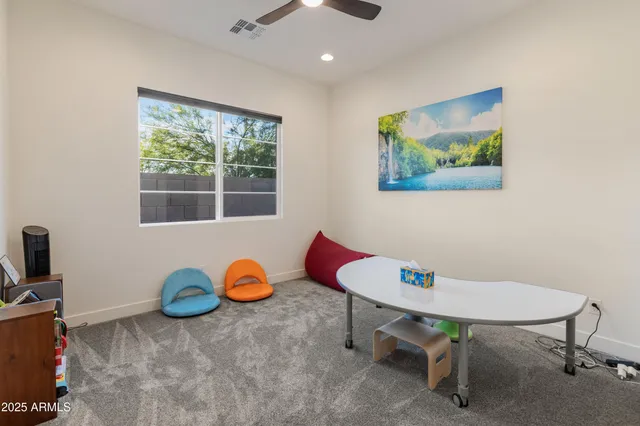 a bedroom with a bed and a painting on the wall