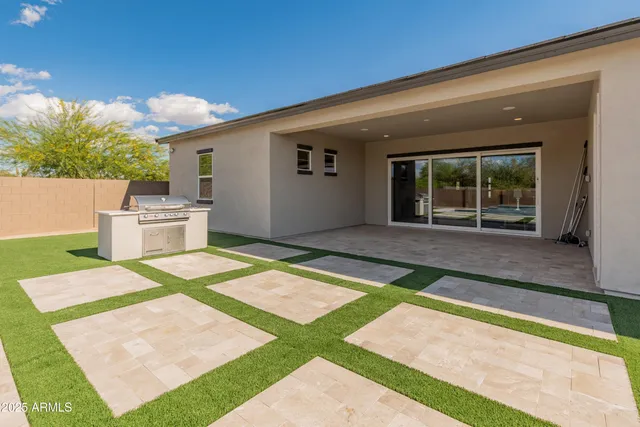 a view of a backyard with swimming pool
