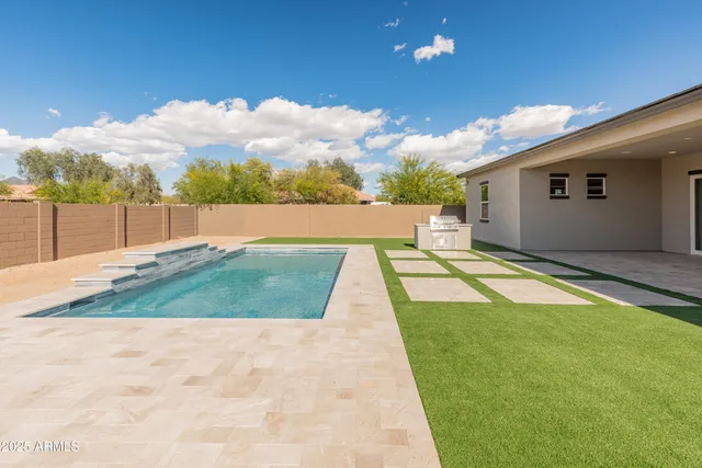 a dining room with furniture a chandelier and wooden floor