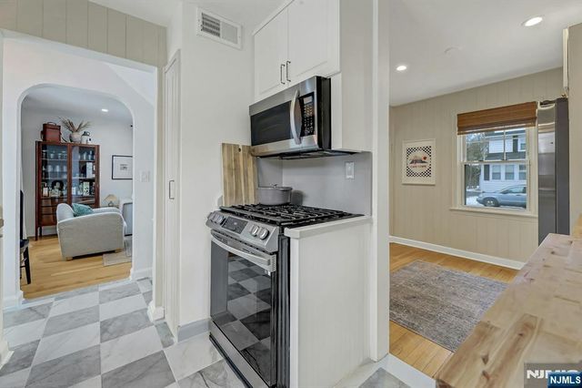 a kitchen with stainless steel appliances granite countertop a stove and a refrigerator