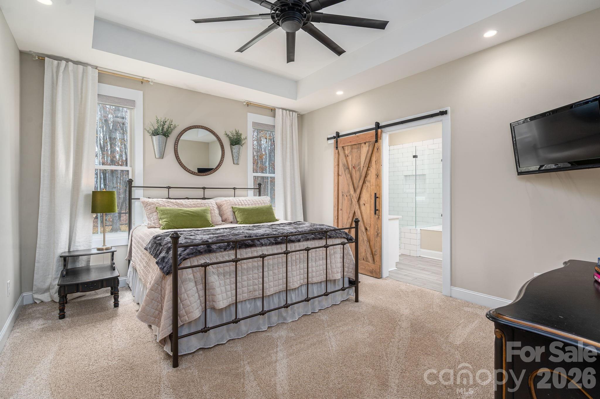 2656 Lee Lawing Road Lincolnton, NC 28092 - Photo 25 of 48 a bedroom with a bed a flat screen tv and a window