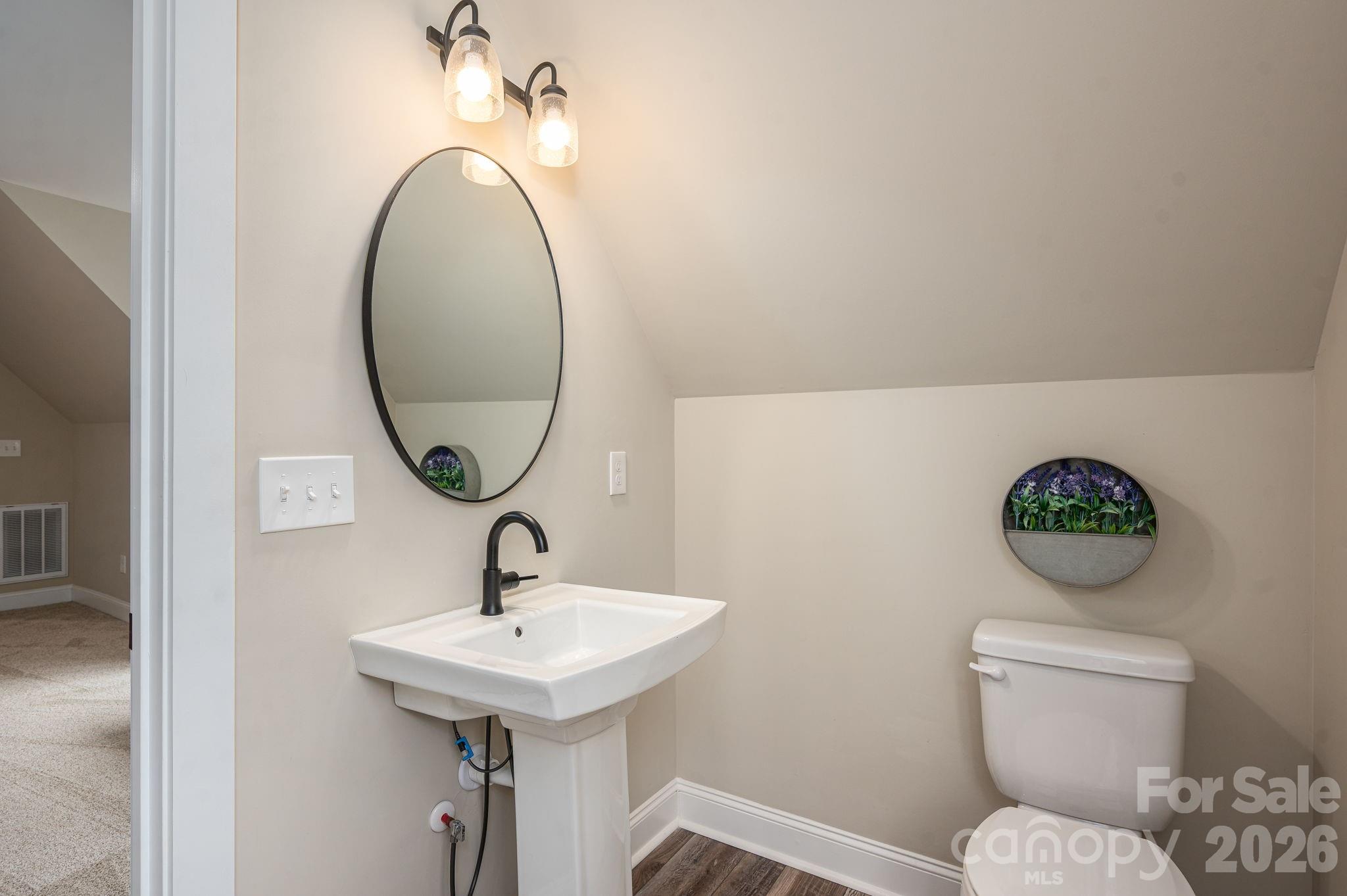 2656 Lee Lawing Road Lincolnton, NC 28092 - Photo 34 of 48 a bathroom with a toilet sink and mirror
