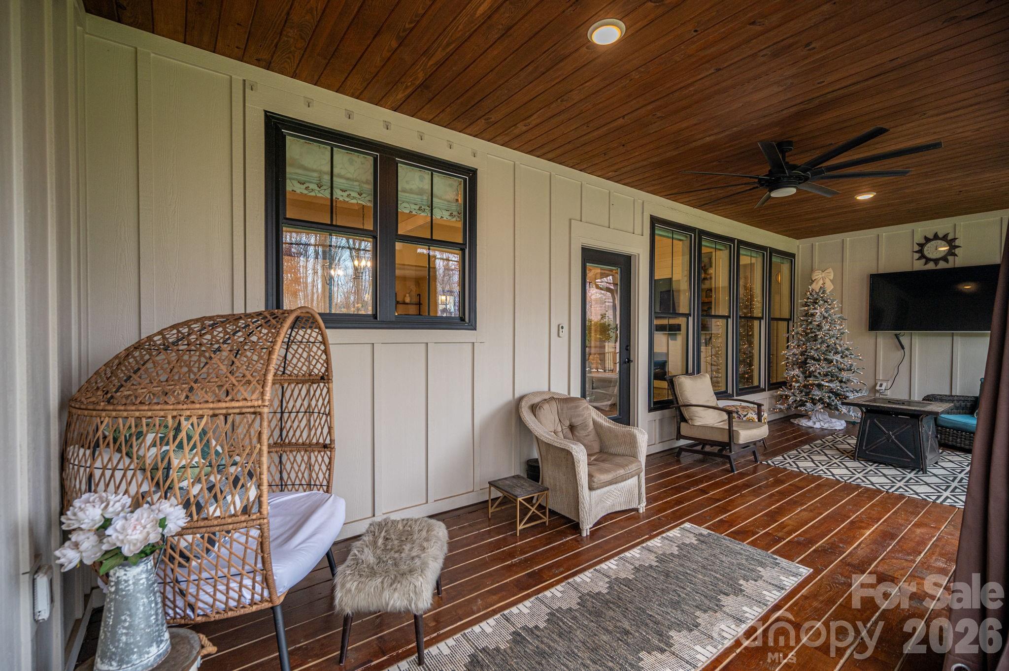 2656 Lee Lawing Road Lincolnton, NC 28092 - Photo 36 of 48 a living room with furniture a flat screen tv and a floor to ceiling window