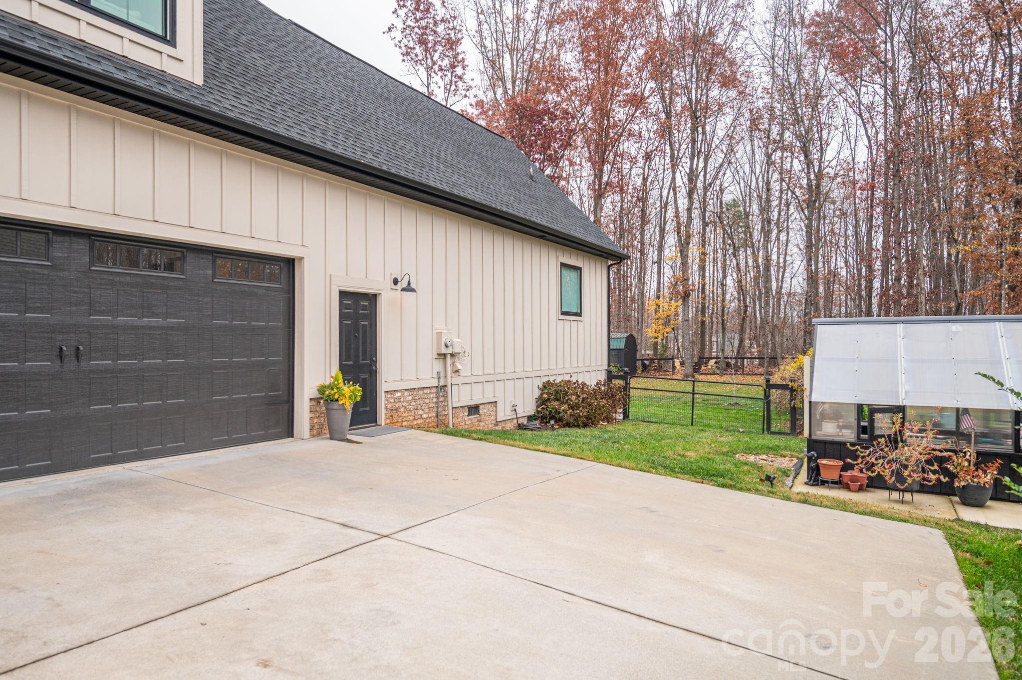 2656 Lee Lawing Road Lincolnton, NC 28092 - Photo 43 of 48 a front view of a house with a yard and garage