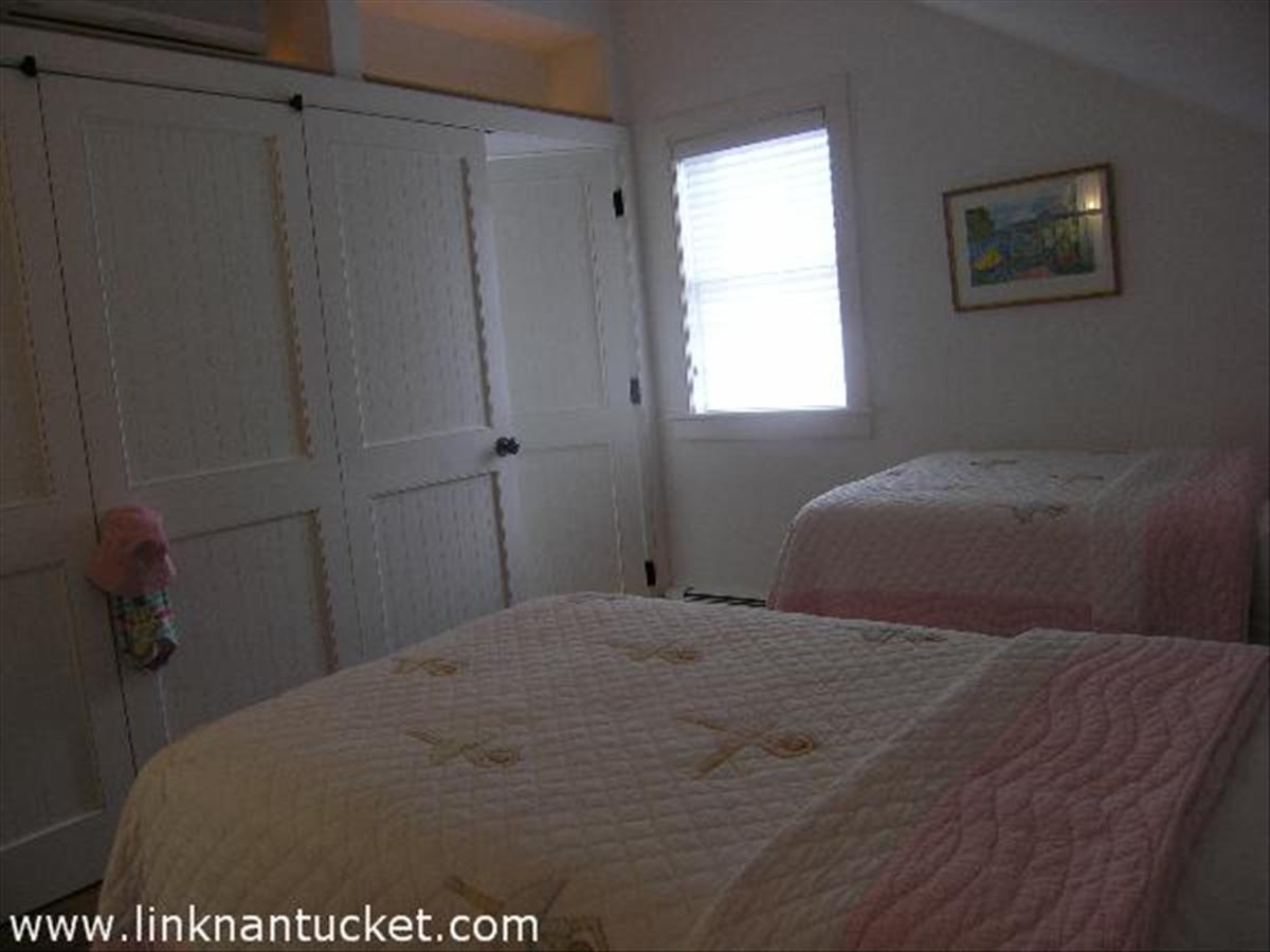 34 R Cliff Road Nantucket, MA 02554 - Photo 11 of 14 a bedroom with a bed and a window