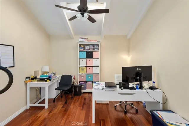 a view of a workspace with furniture and wooden floor