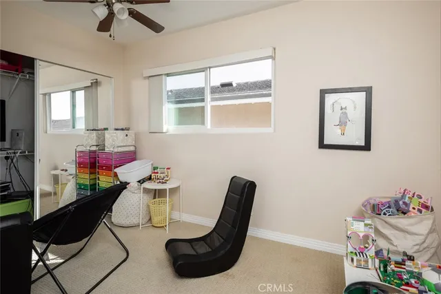 a view of a workspace with furniture and a window