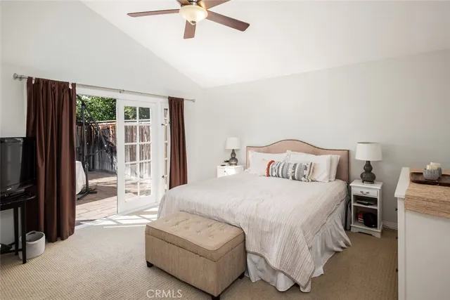 a bedroom with a bed and a flat tv screen