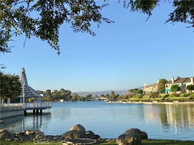 a view of a lake with boats and trees in the background