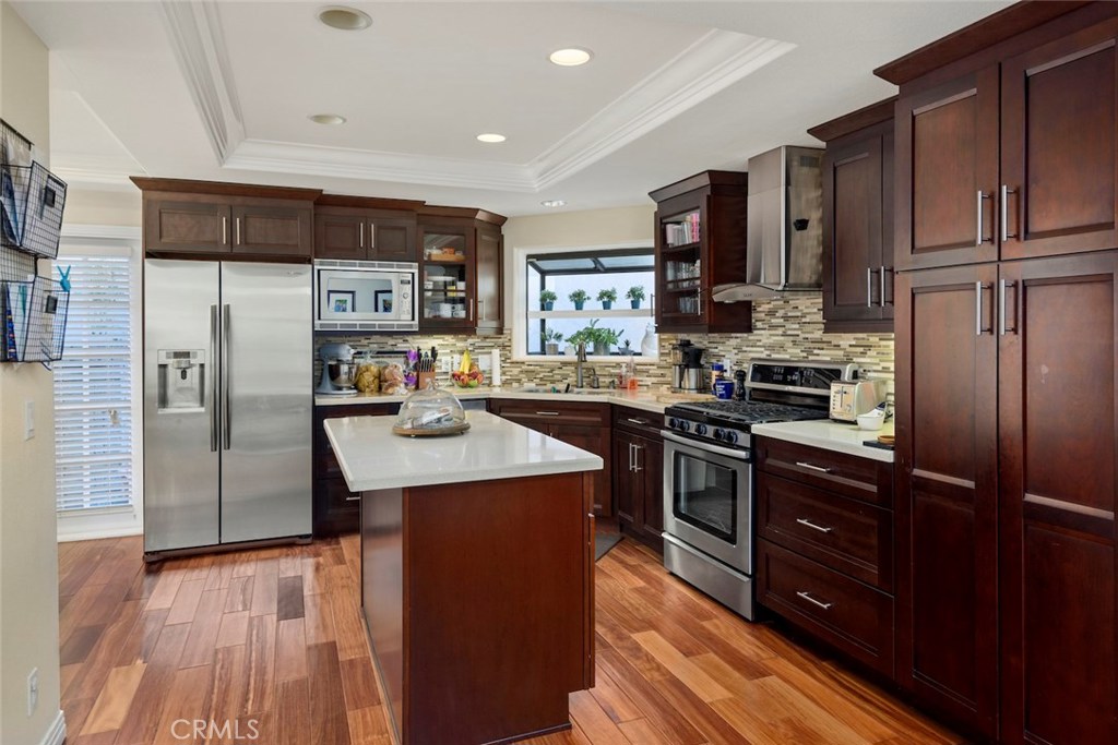 25 Birdsong Irvine, CA 92604 - Photo 6 of 29 a kitchen with stainless steel appliances granite countertop a refrigerator stove and sink