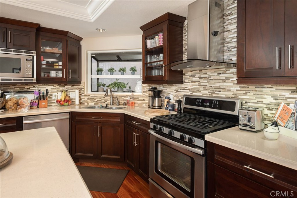 25 Birdsong Irvine, CA 92604 - Photo 8 of 29 a kitchen with stainless steel appliances a sink stove and cabinets