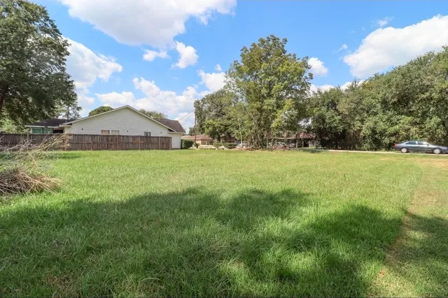 a view of a garden with a house