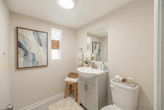 a bathroom with a toilet a sink and a mirror