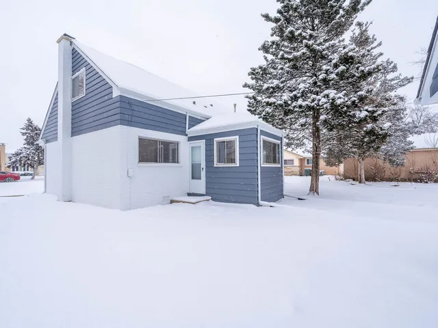 a view of a house with a snow in the yard