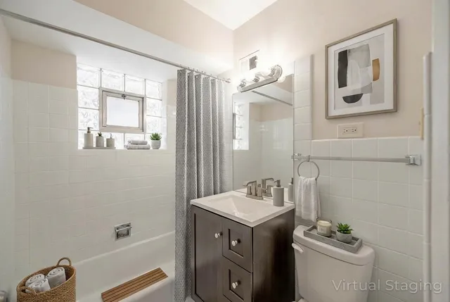a bathroom with a granite countertop sink a toilet and a mirror