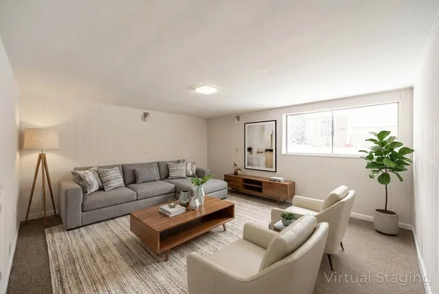 a living room with furniture and a potted plant