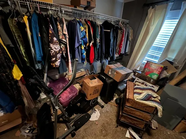 a view of walk in closet with clothes and shoes