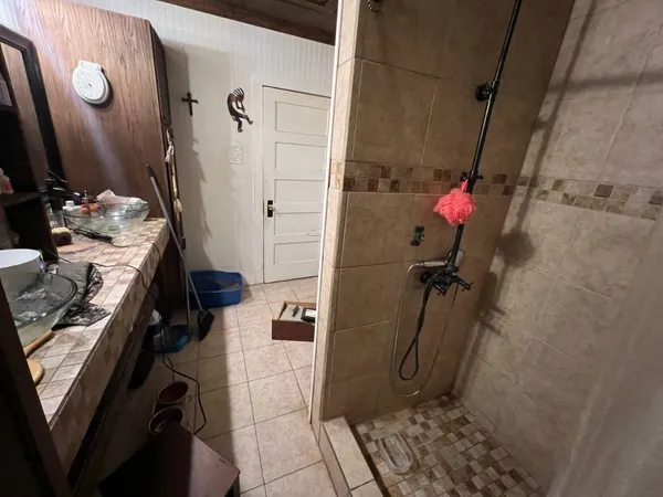 a bathroom with a granite countertop shower