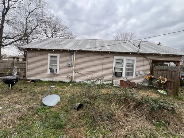 a backyard of a house with yard and outdoor seating