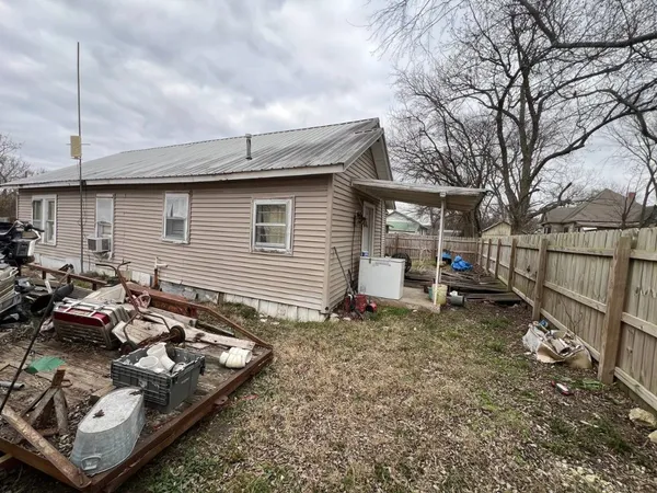 a backyard of a house with table and chairs