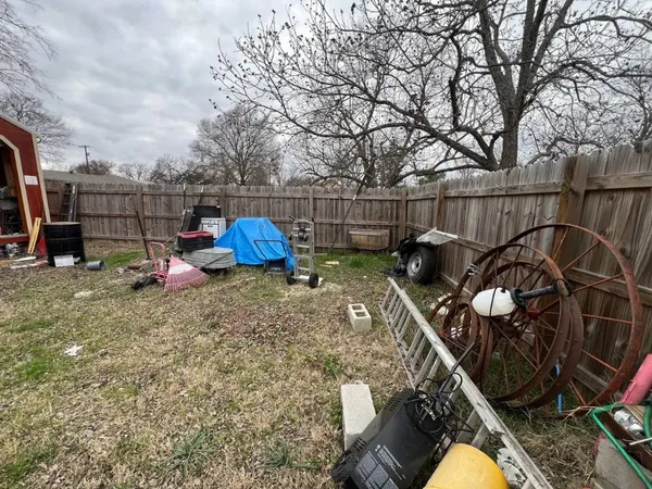 a backyard of a house with barbeque oven