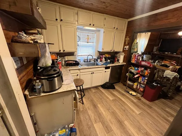 a kitchen with a sink appliances and cabinets