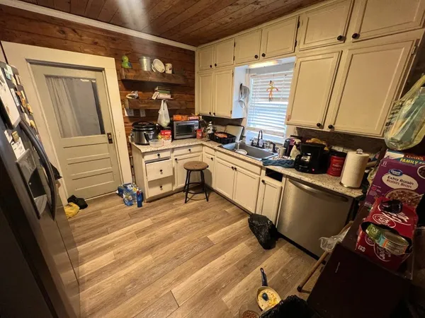 a kitchen with a sink appliances and cabinets